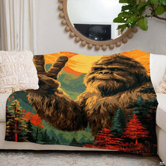 Sunset peace sign Bigfoot blanket styled across an indoor couch beneath a round decorative mirror.