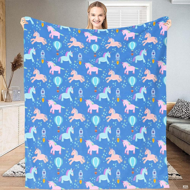 Magical unicorn bedding set featuring whimsical pastel unicorns, hot air balloons, and stars on royal blue.
