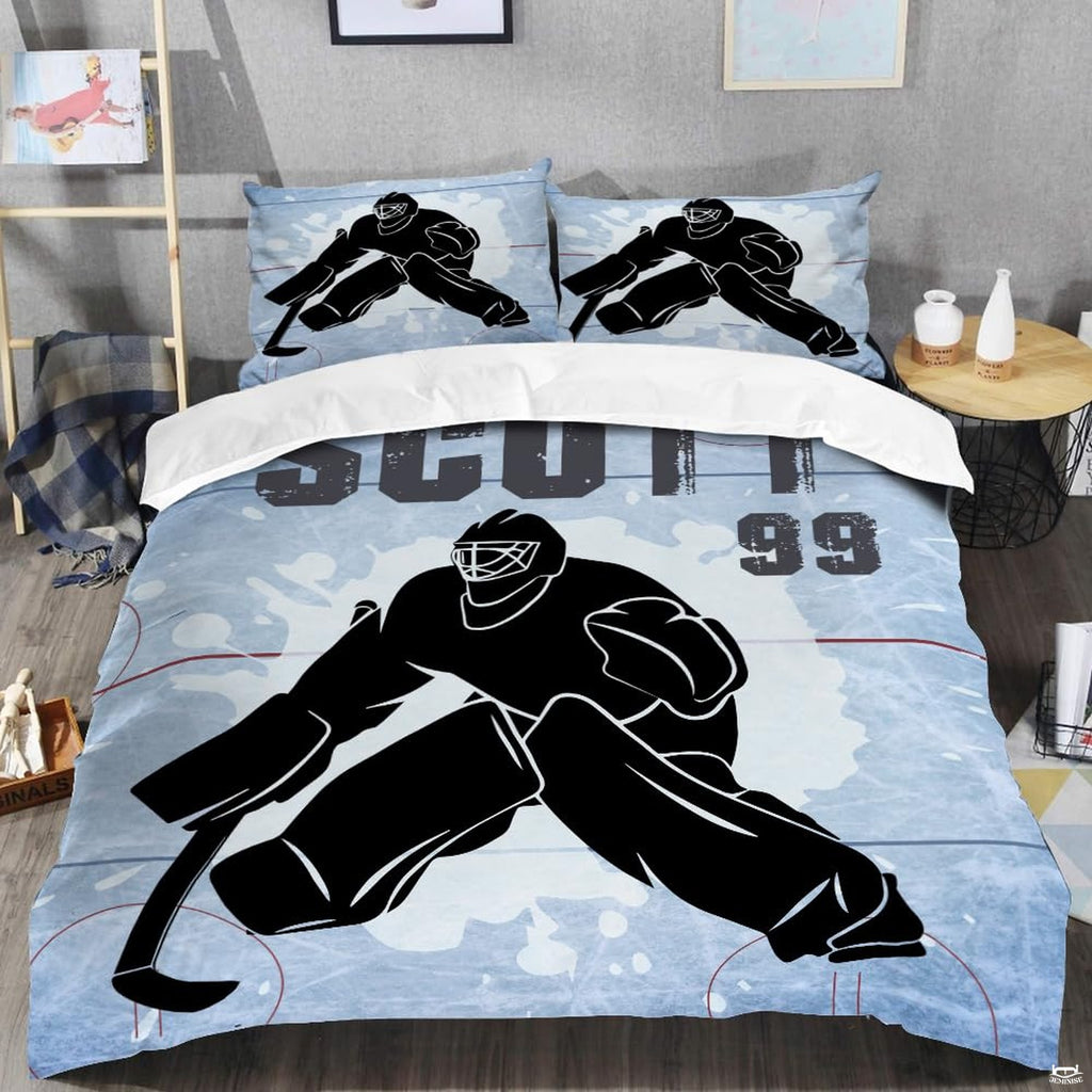 Top-down view of steel blue ice hockey goalie bedding set arranged neatly on a youth bedroom mattress