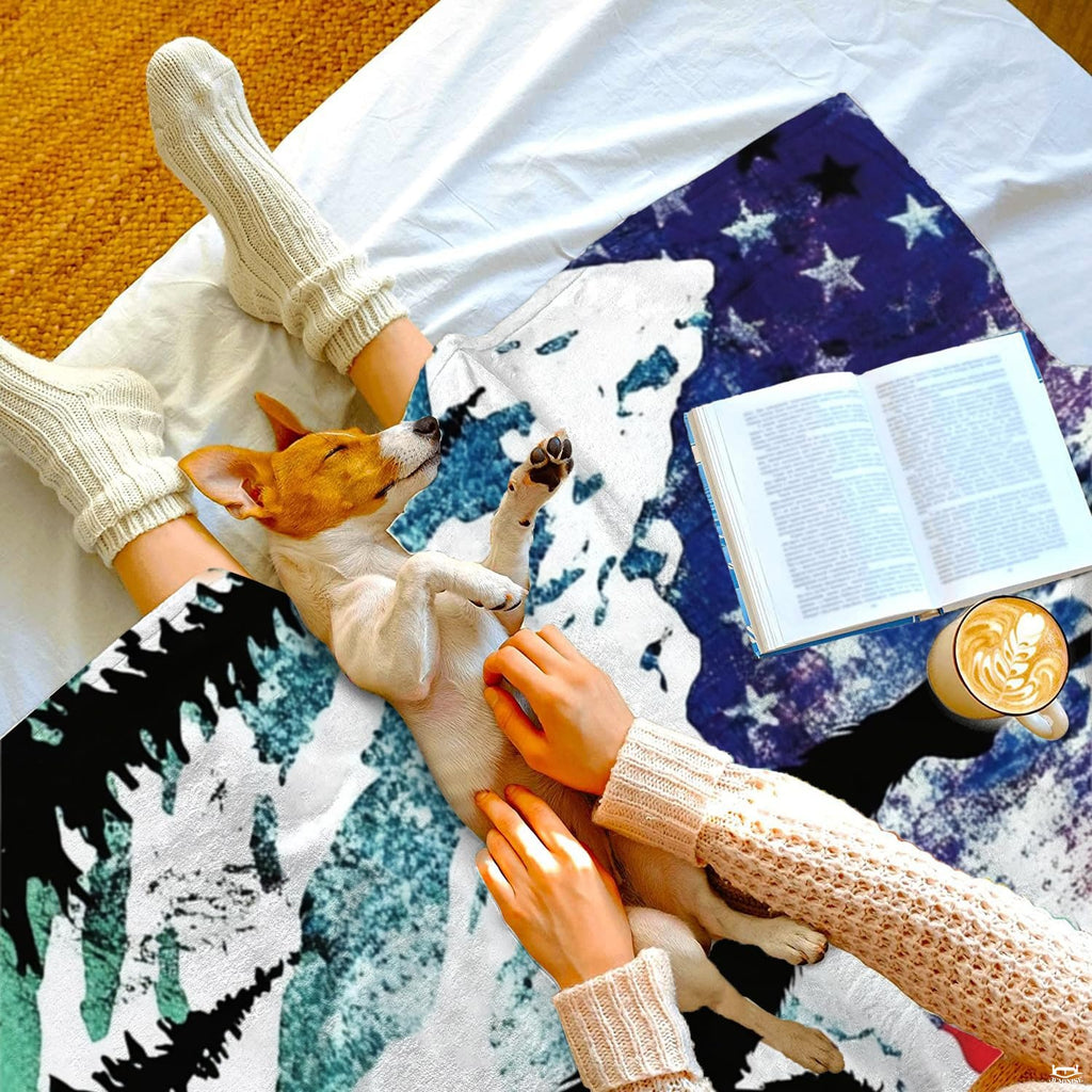 Top-down view of person and dog resting comfortably beneath patriotic throw on bed
