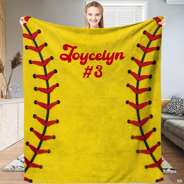 Person standing in bright living room holding up optic yellow fastpitch graphic textile.