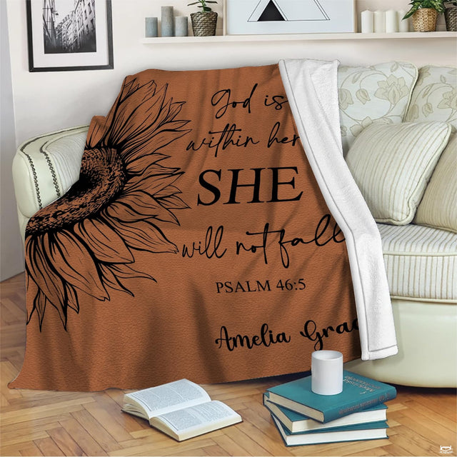 Terracotta sunflower faith throw blanket draped over a neutral living room sofa.