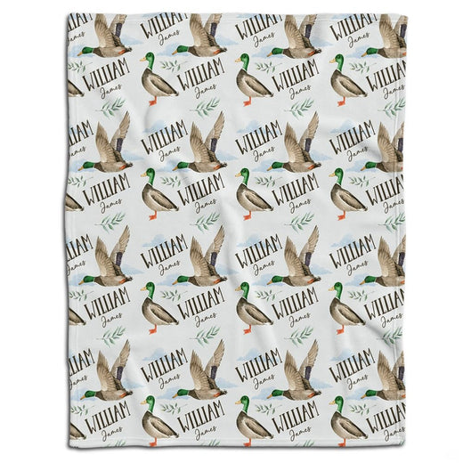 Mallard duck bedding set showcasing standing and flying waterfowl pattern with botanical greenery sprigs on white ground