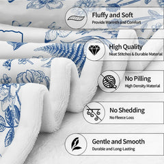 Close up of blue botanical throw blanket displaying cursive typography and intricate tulip sketches