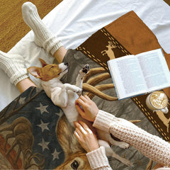 Lifestyle scene showing a small dog on the printed wildlife textile next to an open book.
