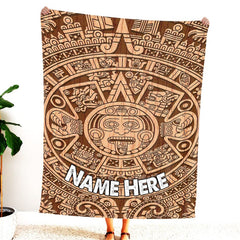 Woman standing indoors holding up carved wood Aztec sun stone graphic textile.