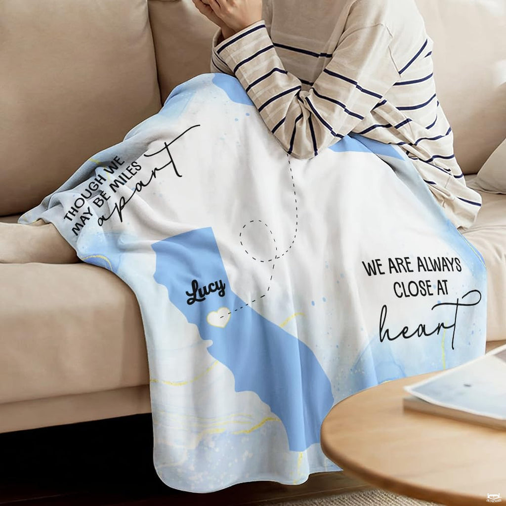 Detail of long distance friendship map throw blanket highlighting heart marker and state silhouette