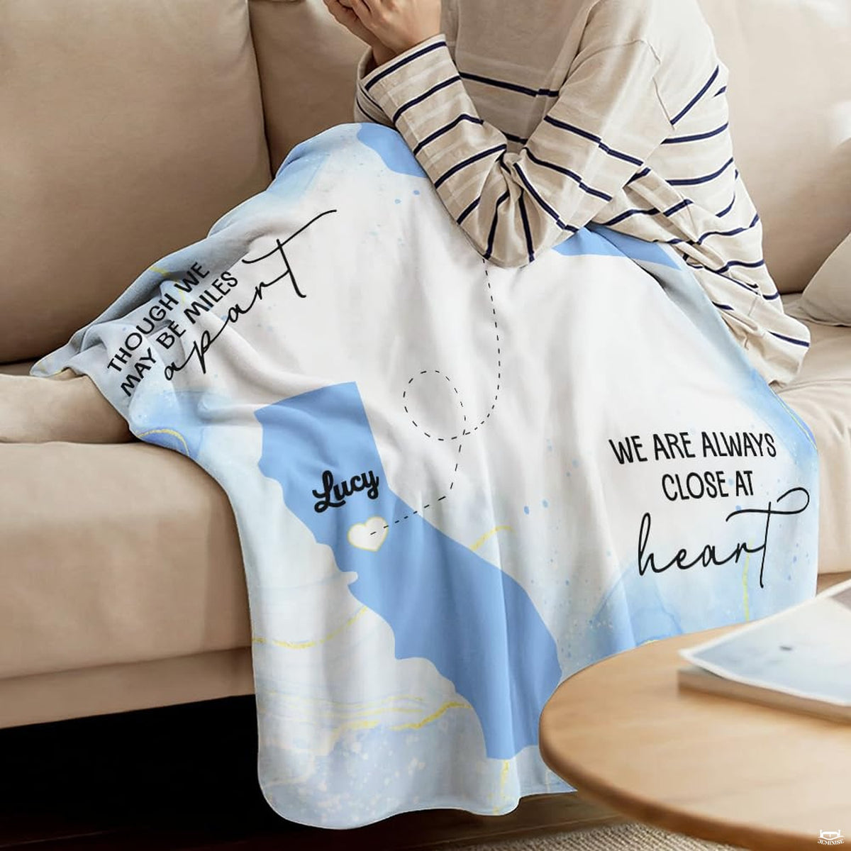 Detail of long distance friendship map throw blanket highlighting heart marker and state silhouette