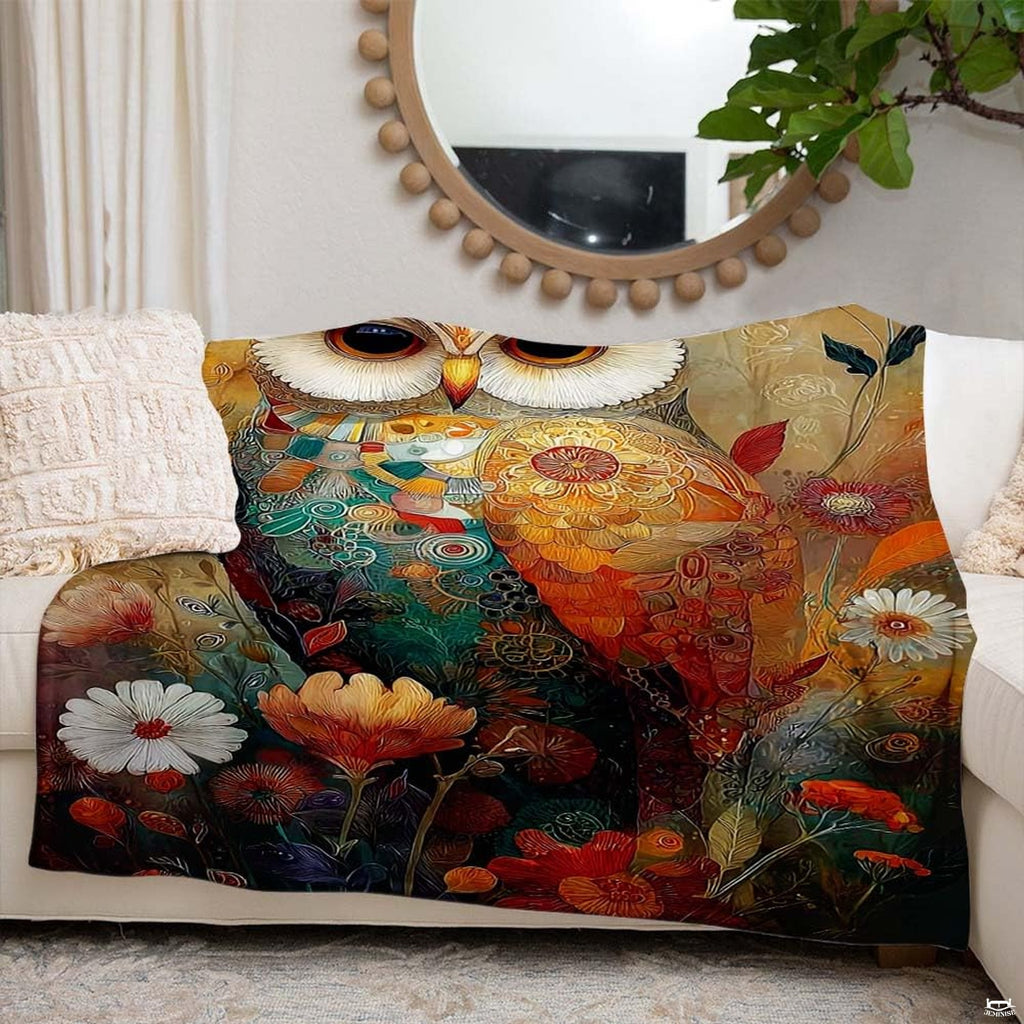 Side angle perspective displaying vibrant amber, turquoise, and coral hues of the owl blanket