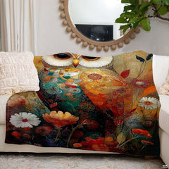 Side angle perspective displaying vibrant amber, turquoise, and coral hues of the owl blanket