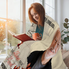 Flat view of sympathy blanket featuring scarlet cardinals on winter branches over wood planks