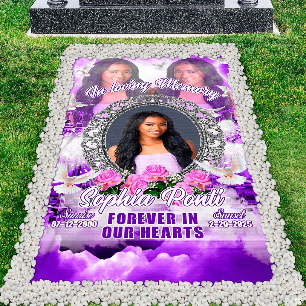 Purple memorial tribute grave blanket displayed on lawn framed by white pebbles