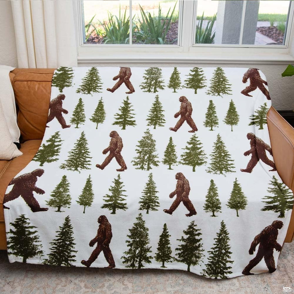 Bedroom decorated with rustic pine forest bedding displaying earthy brown wilderness patterns.