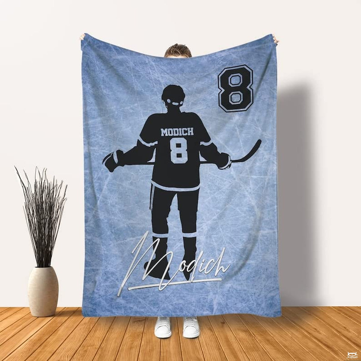 Side angle view of athletic themed bedroom display featuring ice hockey player design