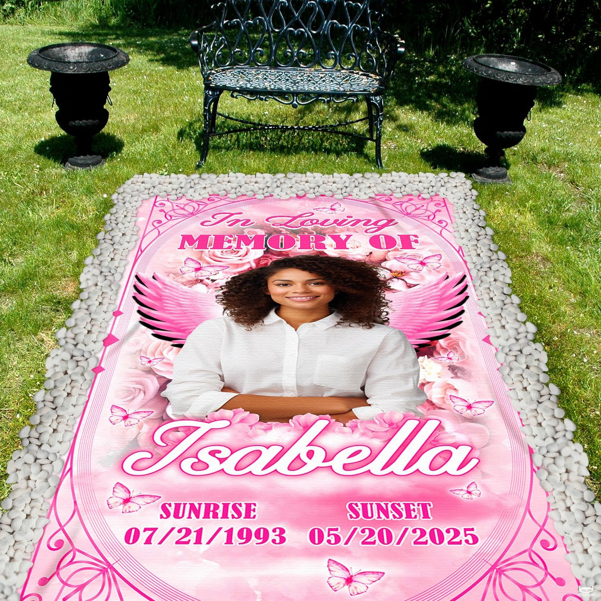 Outdoor garden perspective featuring pink tribute between decorative urns and park bench.