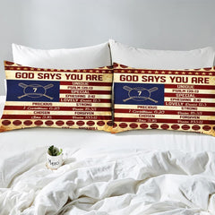 Side angle view of athletic sports bedding showing navy blue and scarlet red tones draped on mattress