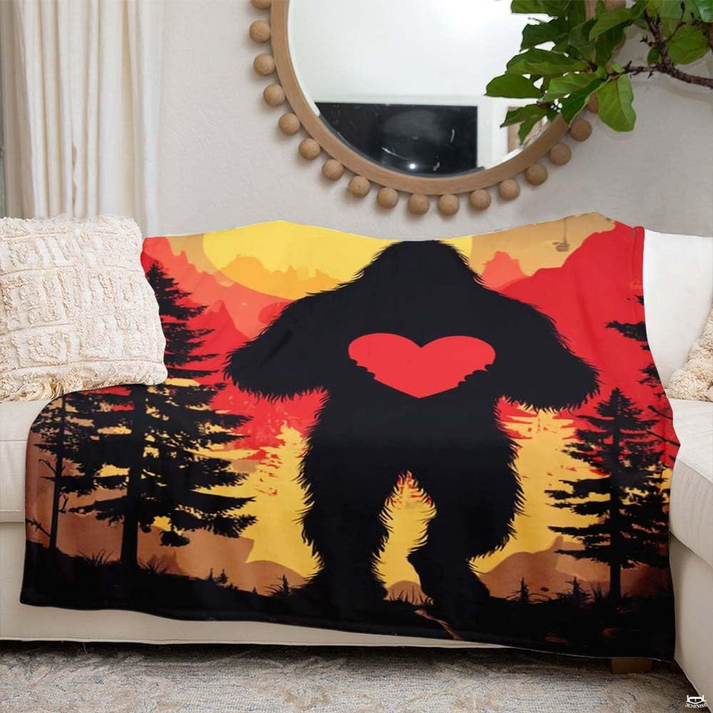 Bigfoot holding heart throw blanket view 6 highlighting Sasquatch silhouette, scarlet heart, and sunset sky