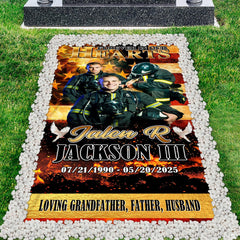 Firefighter memorial grave blanket installed over lawn grave site bordered by river pebbles