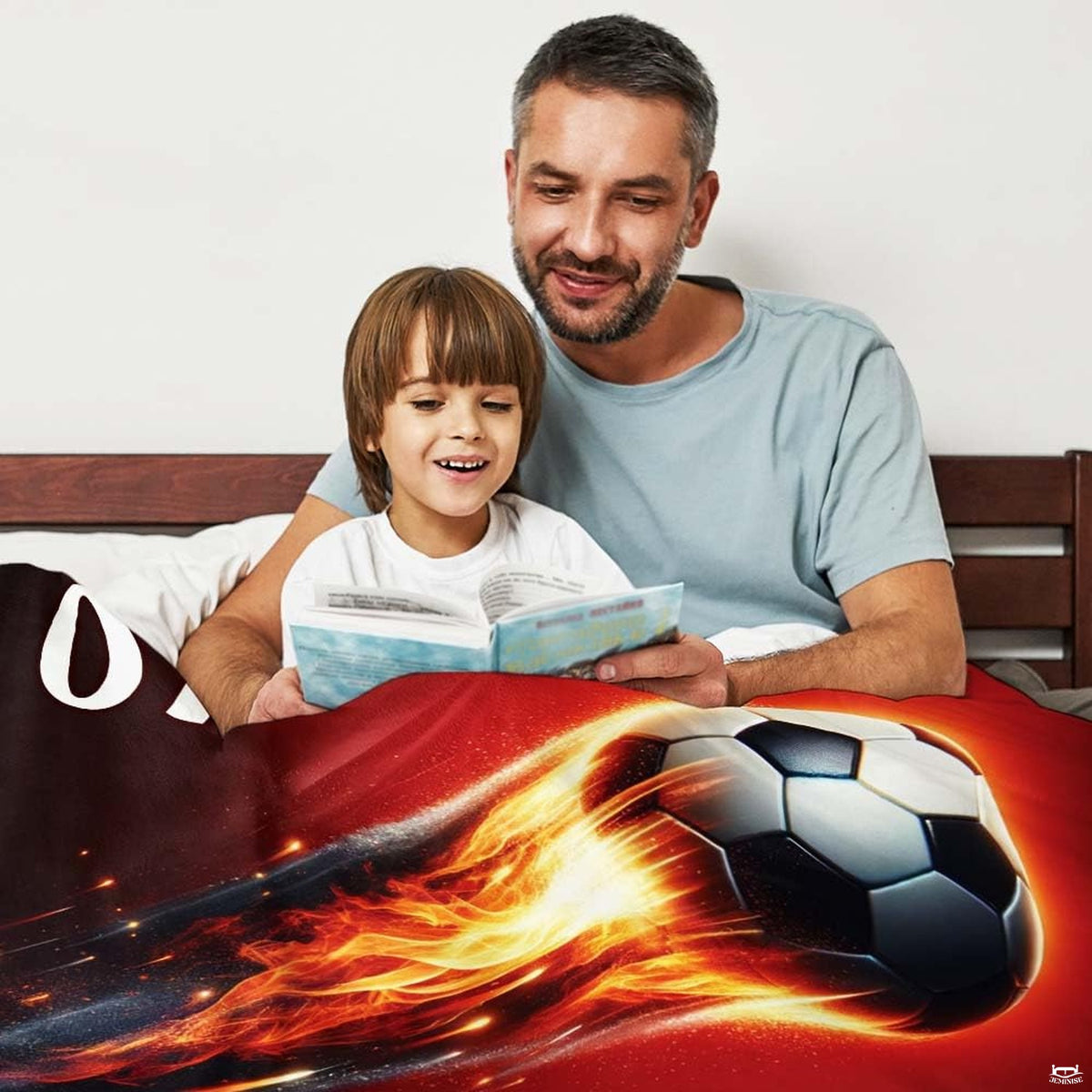 Bed setting with parent and child reading book beneath the dynamic fiery soccer graphic.