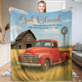 Vintage red pickup truck in golden wheat field with rustic barn and windmill, view 1.