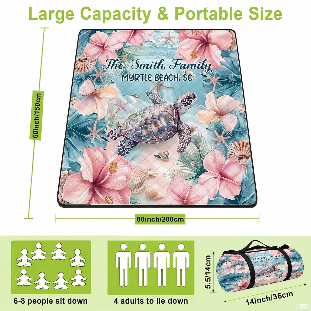 Close-up detail of illustrated sea turtle and pink hibiscus florals on beach blanket