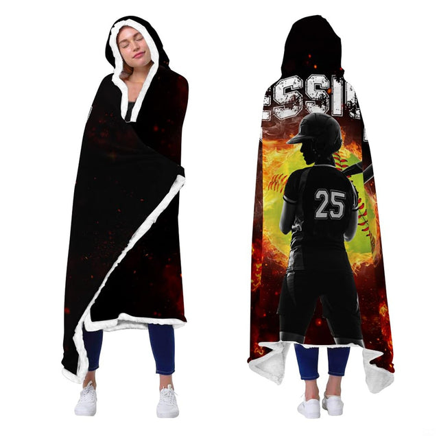 Model presenting front and back perspective of black wearable hooded textile with flaming softball artwork.