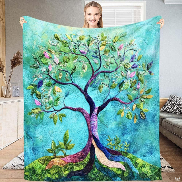 Model displaying throw blanket featuring batik mosaic tree of life with violet branches on turquoise