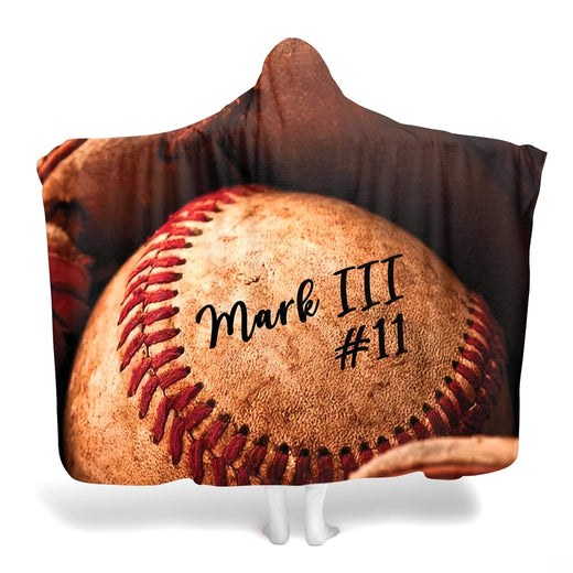 Frontal view of close-up weathered baseball with red laces and mitt in sepia tones.