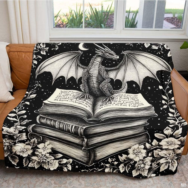 Living room sofa displaying the monochrome gothic dragon book stack throw blanket.