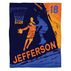 Dynamic basketball player silhouettes and orange paint splatters on deep navy bedding set.