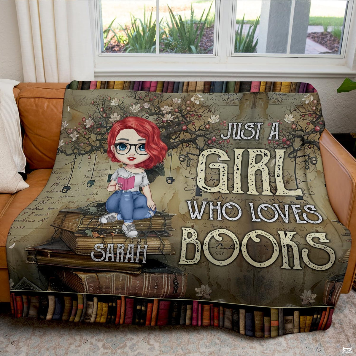 Detailed view of cartoon bookworm girl reading a pink book on literary throw blanket.