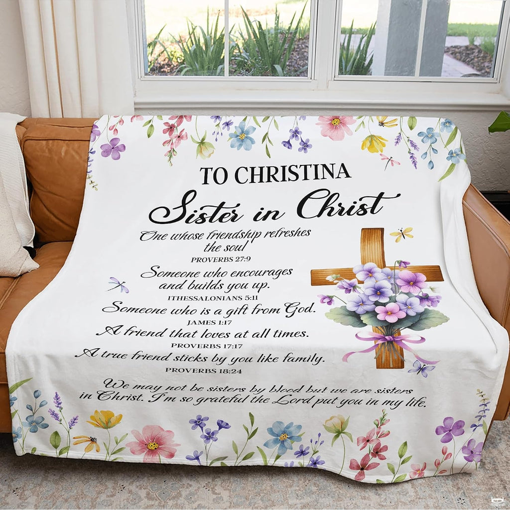 Botanical garden bedding with central wooden cross accent tied in a lavender ribbon on an off-white background.