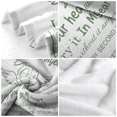 Living room sofa displaying the commemorative winged footprints throw blanket draped over furniture.