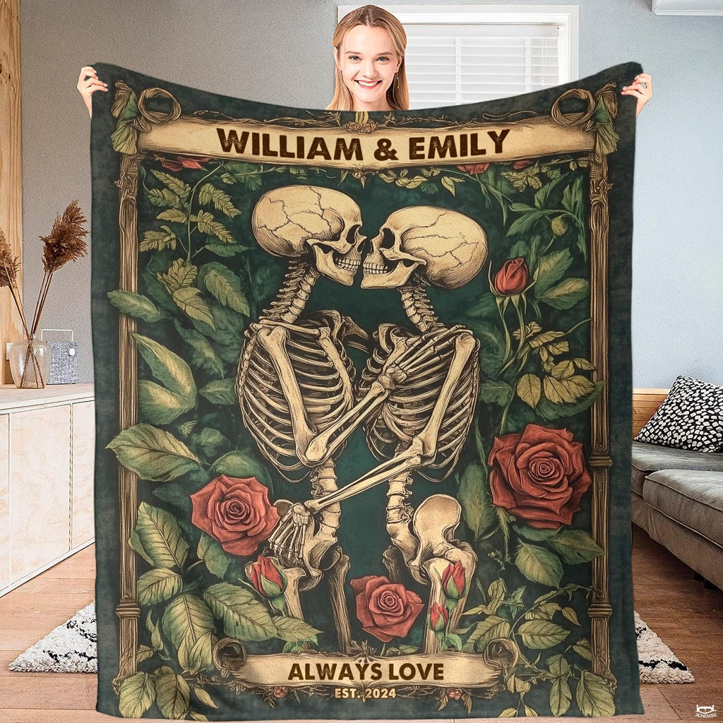 Living room sofa displaying the gothic skeleton kiss throw blanket draped over furniture.