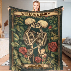 Living room sofa displaying the gothic skeleton kiss throw blanket draped over furniture.
