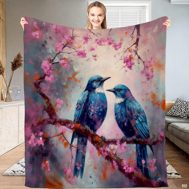 Bluebirds on cherry blossom throw blanket featuring pair of painted bluebirds on blooming pink floral tree bough