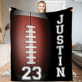 American football lacing sports throw blanket displaying russet pebble grain ball and white laces