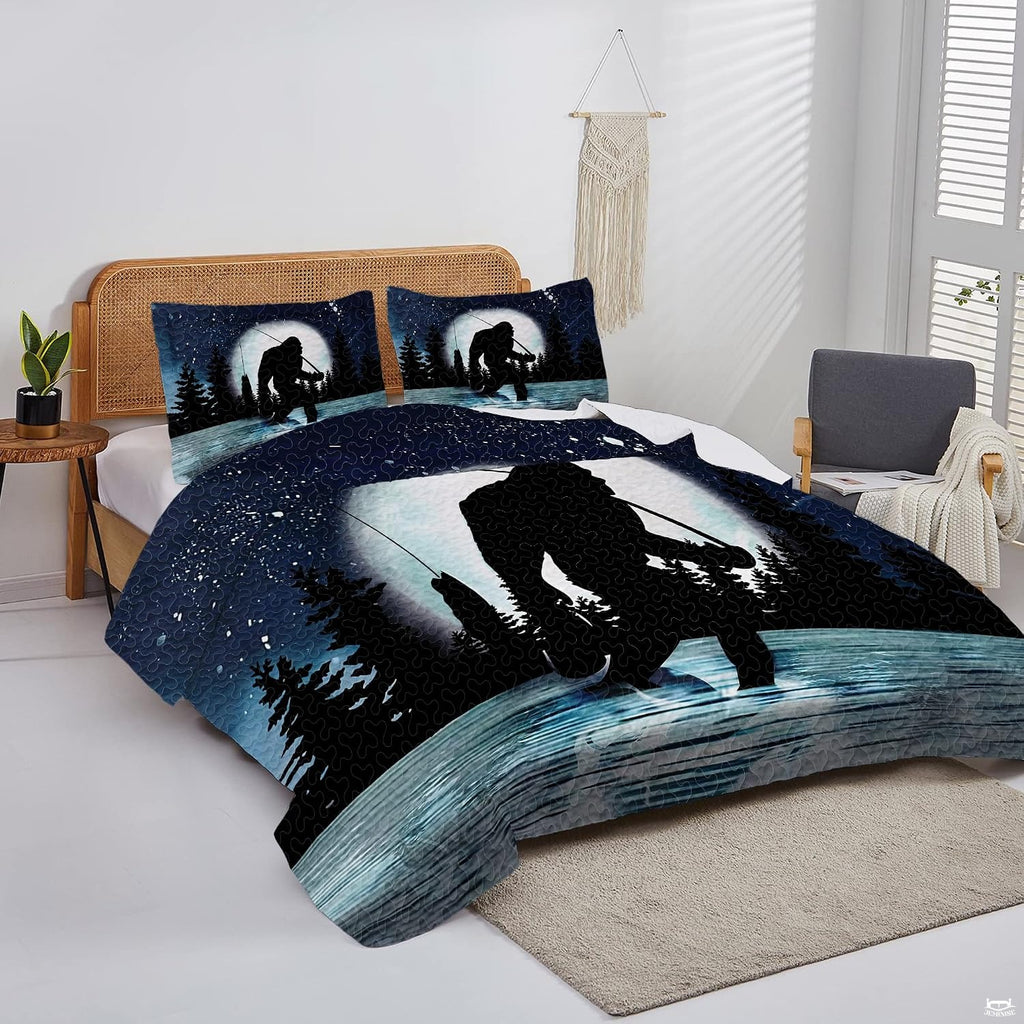 Overhead view of moonlit Bigfoot bedding arranged neatly across a lakeside cabin mattress