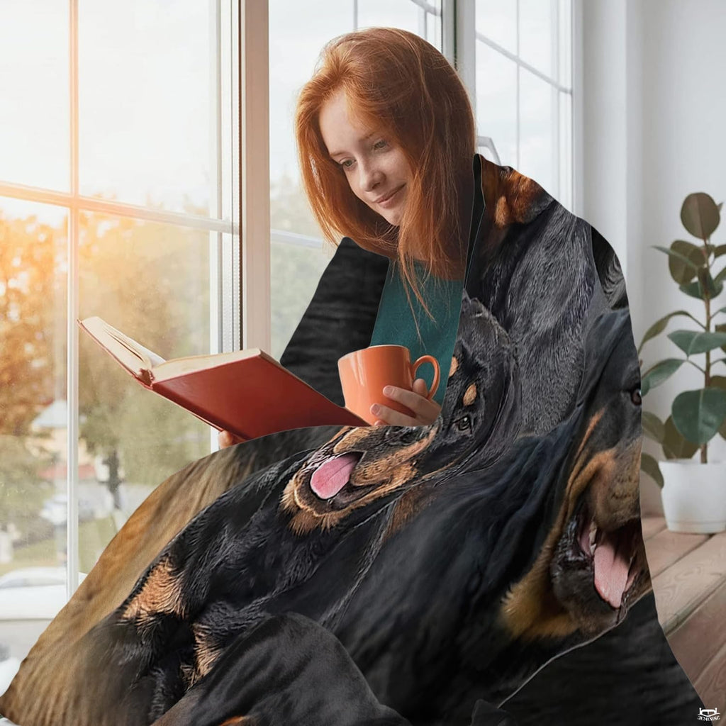 Close view of smiling Rottweiler dog face and mahogany markings on blanket