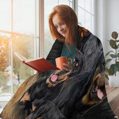Close view of smiling Rottweiler dog face and mahogany markings on blanket