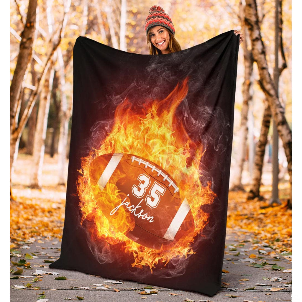 Folded athletic blanket highlighting orange fire burst and smoke trails