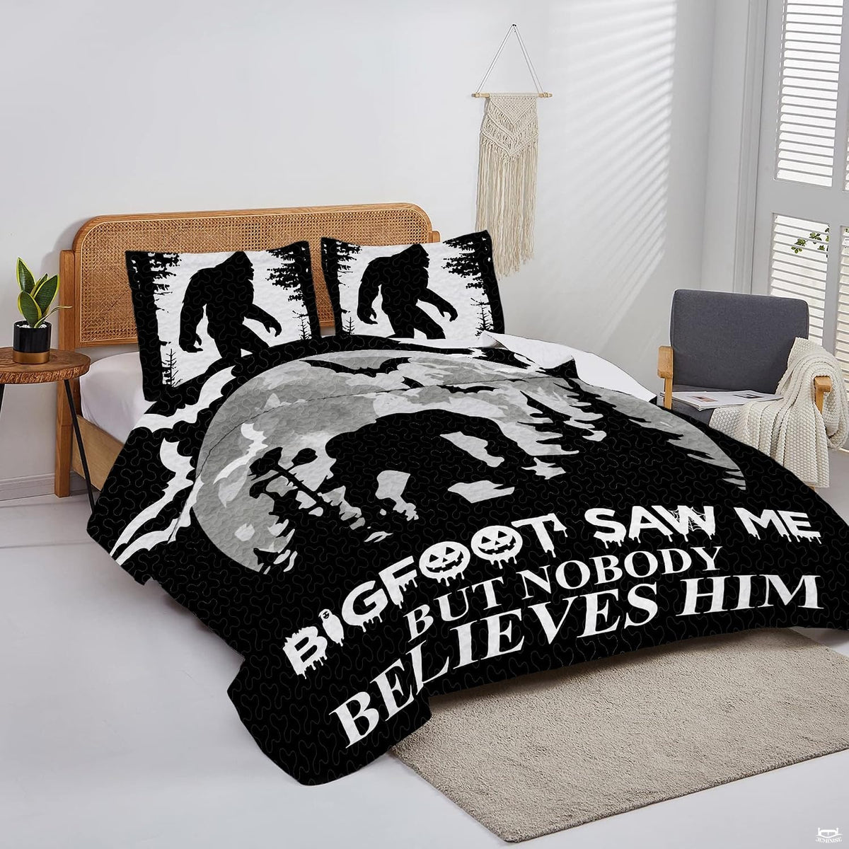 Overhead view of humorous Bigfoot bedding arranged neatly across a rustic bedroom mattress