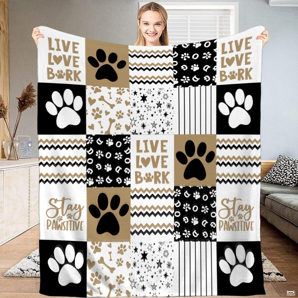 Dog paw print patchwork bedding set in beige, tan, and black with bone icons.