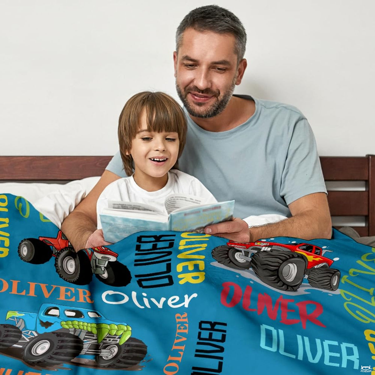 Close-up perspective of shark-themed monster truck and oversized treads on colorful throw blanket