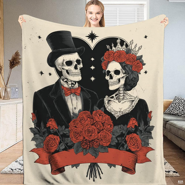 Gothic skeleton couple throw blanket featuring bride and groom in top hat with red roses on cream