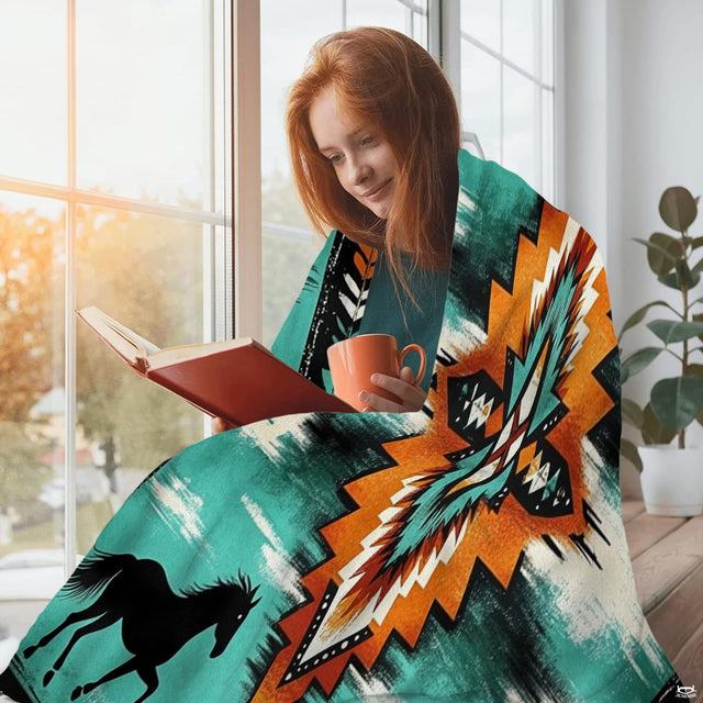 Close-up of central starburst and diamond artwork on Aztec horse bedding set surrounded by tribal arrow borders.