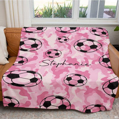 Close view of floating soccer balls on pink camouflage background
