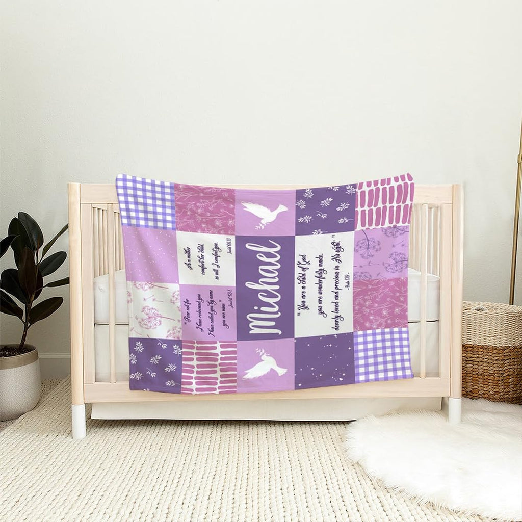Lavender patchwork piece draped over the wooden railing of a light timber nursery crib.