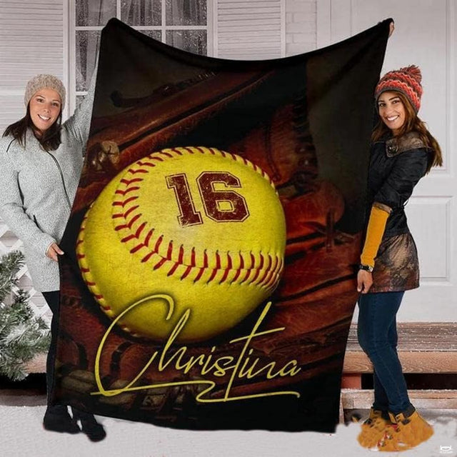 Softball and mitt throw blanket held upright showcasing yellow ball, glove, and golden script.