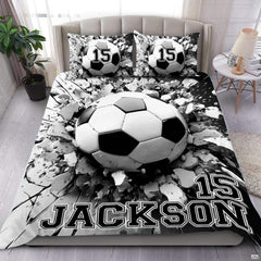 Soccer bedding displaying 3D soccer ball bursting through shattered concrete fissures on monochrome background